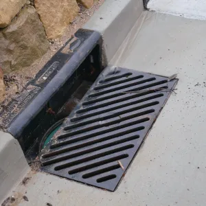 Rainwater entering a storm drain leading to the Pritzlaff Conservation Center bioswale