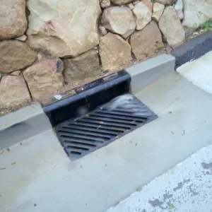 Rainwater entering a storm drain leading to the Pritzlaff Conservation Center bioswale