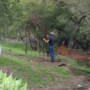 Adam Kuster constructing arch for the Centennial Maze