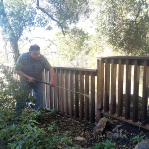 Jim Lechuga pressure washing fence at Water Wise Home Garden