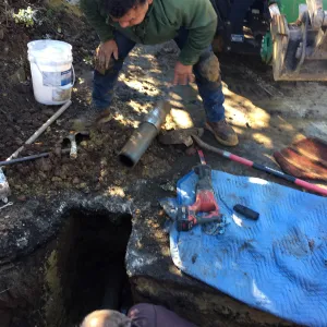 Jim Lechuga and Dave Kershaw working on irrigation water line repair in main parking lot, just south of the bike rack