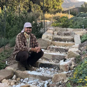 Jacob Cobian at the completion of a new rock staircase on the west side of the PCC. Built entirely by hand out of sandstone from Montecito landslide materials. Side blocks all hand cut and stacked. Filled with crushed stone, layered with soil and gravel.
