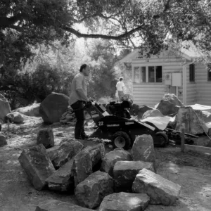 Construction crew at work in front of Cottage. Patio and rock wall construction - Home Demonstration Garden