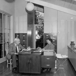 The first letter in the new office is dictated by Mr. Bullard to Miss Frances Hannah, office secretary.