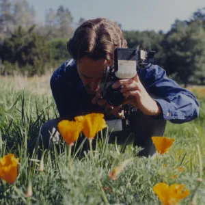 Steve Junak taking photographs in the meadow