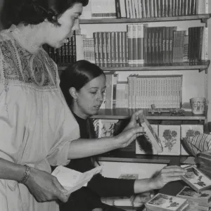 Jacqueline Broughton and Martha Cummings sorting notecards in shop