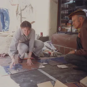 Judy Sutcliff and Dara Emery installing tiles at La Arcada