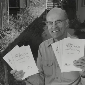 Dara Emery with copies of 'Seed Propagation of Native California Plants'