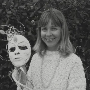 Tara Vance shows off one of the Solstice Parade Masks from her class at the Botanic Garden