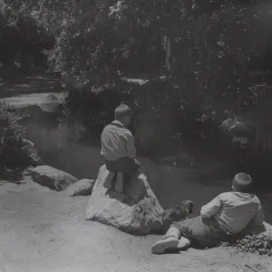 two boys with puppy at the pond