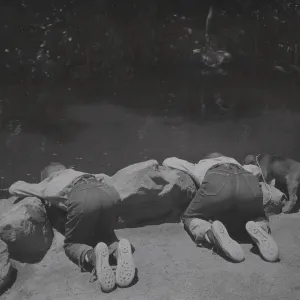 two boys with puppy at the pond
