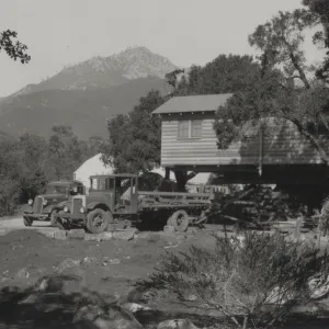 Moving the Cottage building, with greenhouse in background