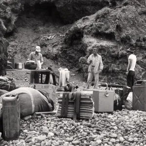A field crew from the Garden organizes collecting and camping gear on the rocky beach of Anacapa Island