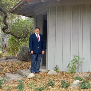 Ed Schneider standing at Information Kiosk after Renovation