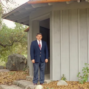 Ed Schneider standing at Information Kiosk after Renovation