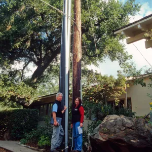 New power pole installed adjacent to the old wooden 'acorn granary' pole