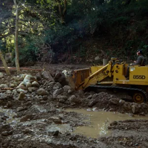 Mission Creek flooded above Mission Dam, with a bulldozer