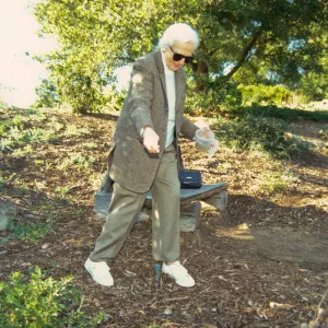 Ann Jones sowing wildflower seeds, Porter Trail, wood bench