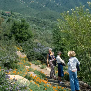 People on trail mountains in the background