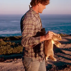 Wayne Pero, National Park Service employee, rabbit caught by Signal Peak, Santa Barbara Island